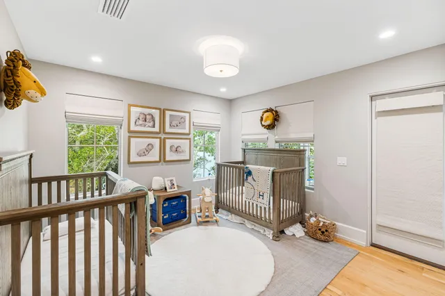 a spacious bedroom with a bed and a chandelier