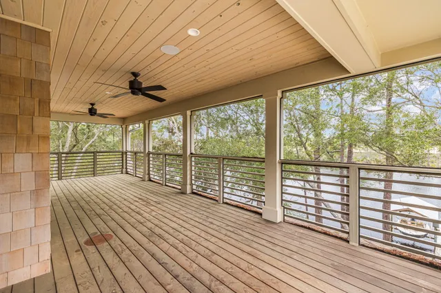 a living room with stainless steel appliances furniture a rug and a kitchen view
