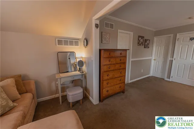 a living room with furniture and a baby crib