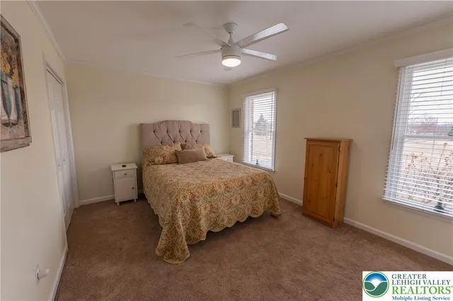 a spacious bedroom with a bed and a window