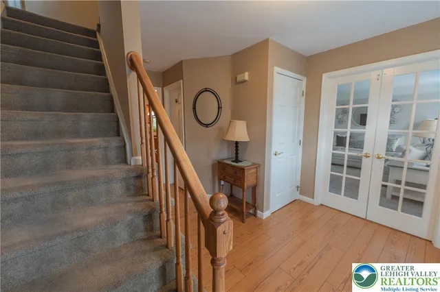 a view of entryway and hall with wooden floor