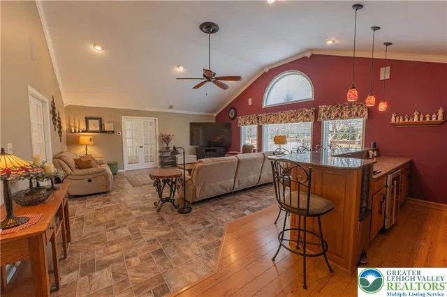 a living room with furniture a fireplace and a chandelier