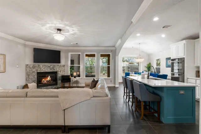 a living room with furniture a fireplace and a flat screen tv