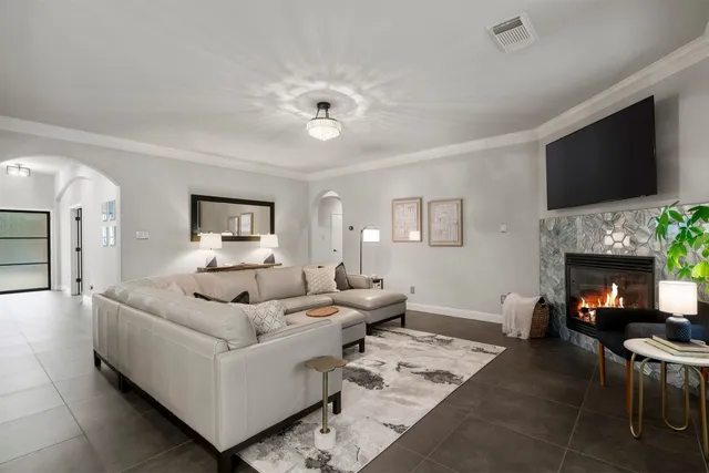 a living room with furniture a fireplace and a flat screen tv