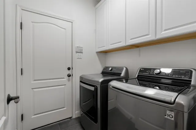 a view of an empty room with kitchen appliances and a ceiling fan