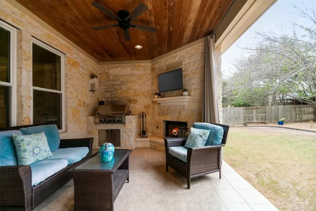 a view of a house with large windows and a table and chairs