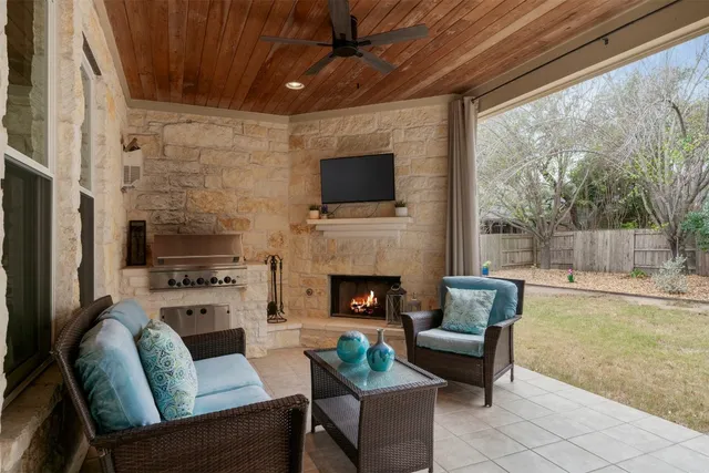 a living room with furniture a flat screen tv and a fireplace