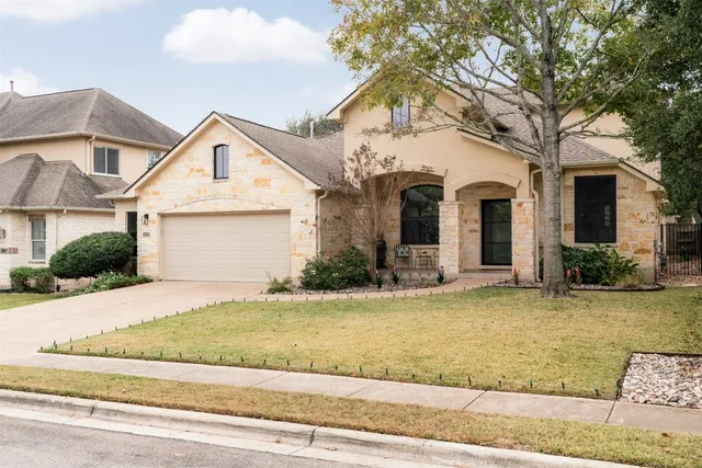 a front view of a house with a yard and garage