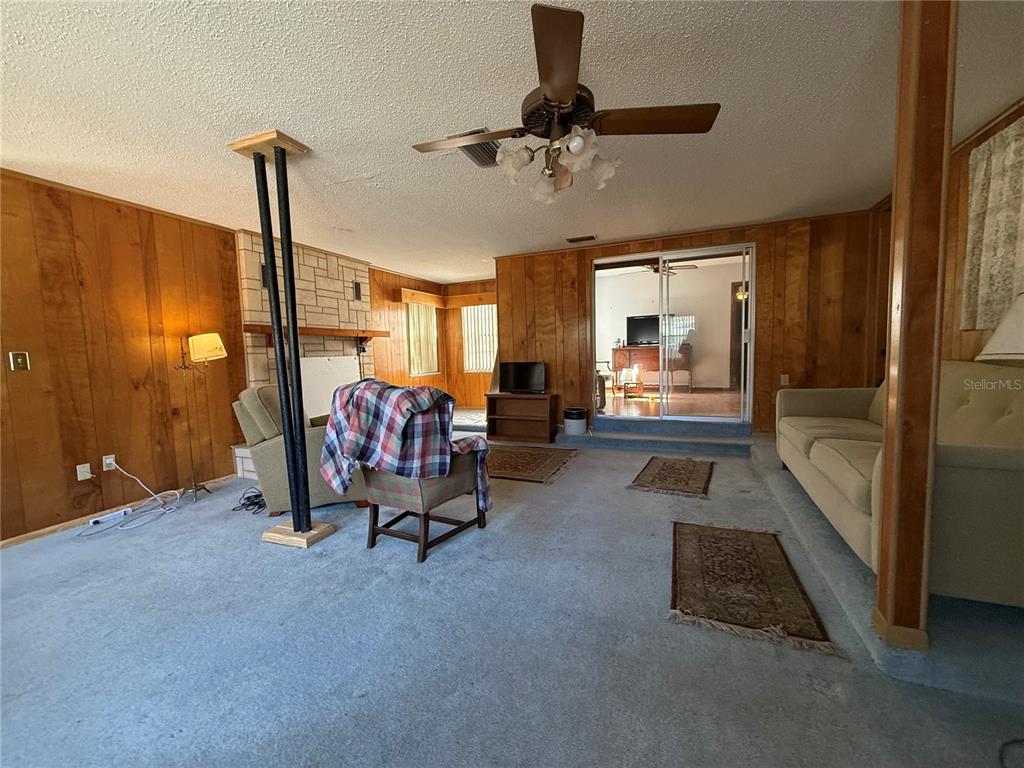 2200 Butler Street Leesburg, FL 34748 - Photo 12 of 32 a living room with furniture and a chandelier