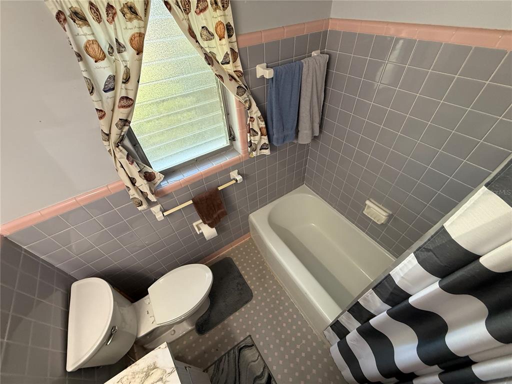 2200 Butler Street Leesburg, FL 34748 - Photo 14 of 32 a bathroom with a toilet and a mirror