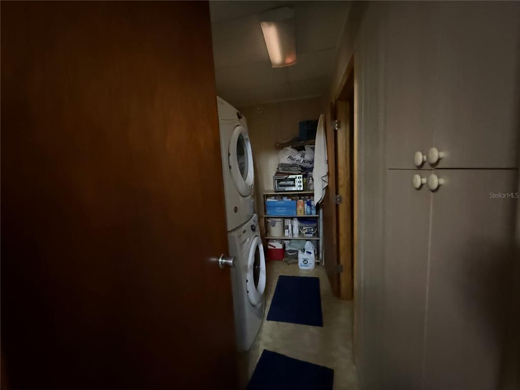 2200 Butler Street Leesburg, FL 34748 - Photo 23 of 32 a view of a hallway with wooden shelves