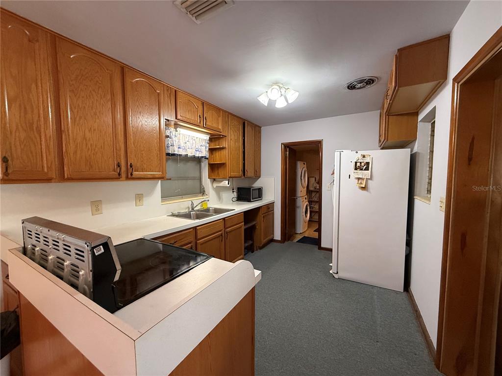 2200 Butler Street Leesburg, FL 34748 - Photo 7 of 32 a view of kitchen with refrigerator stove microwave and cabinets