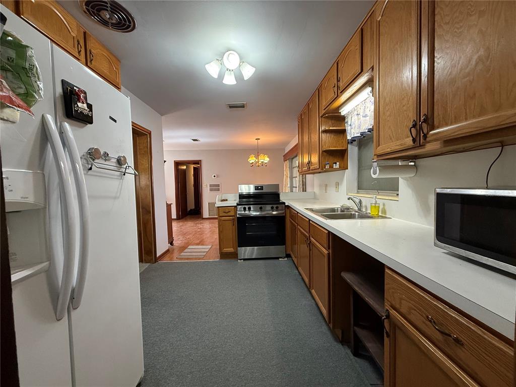 2200 Butler Street Leesburg, FL 34748 - Photo 8 of 32 a large kitchen with stainless steel appliances and a refrigerator