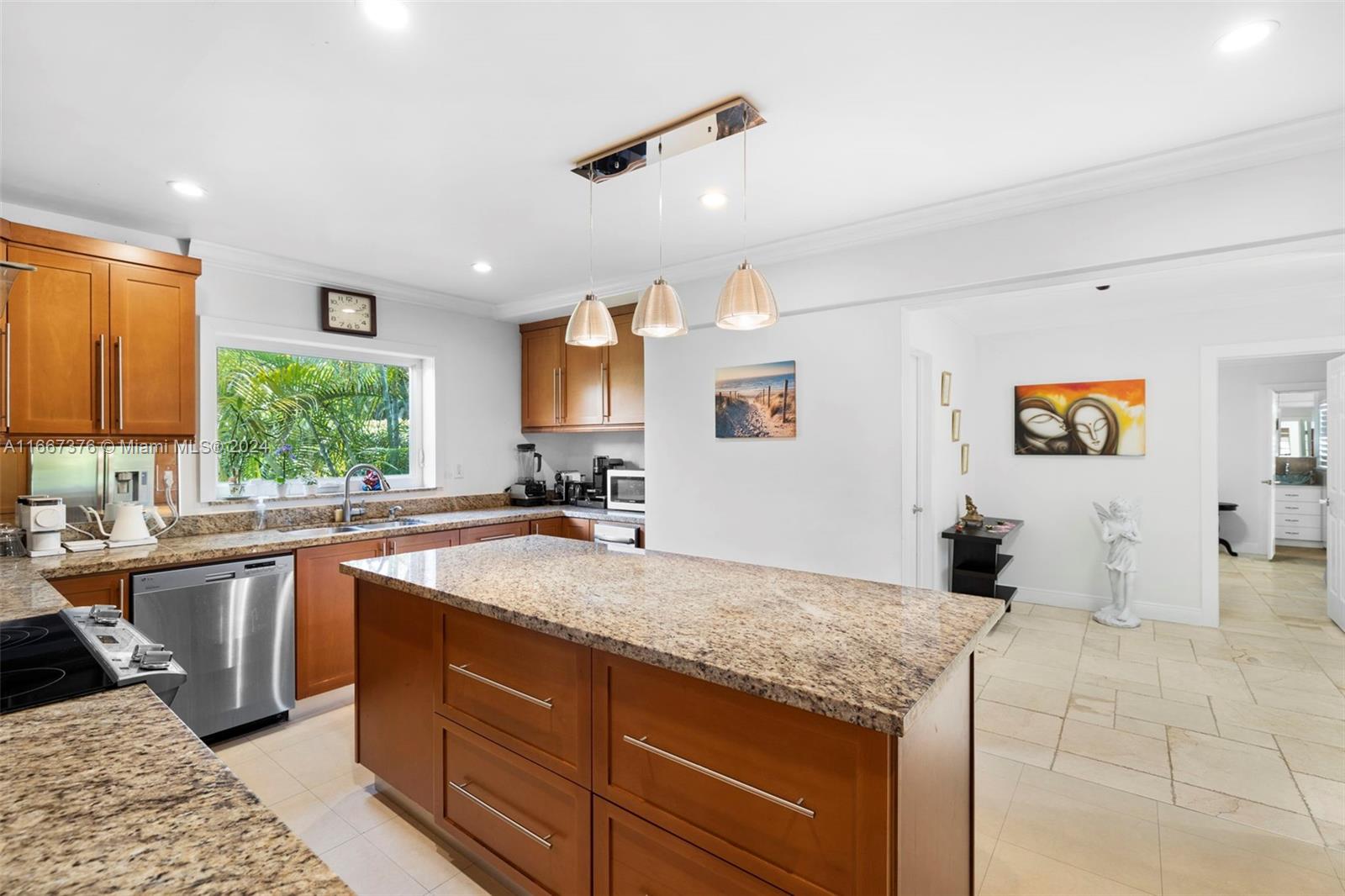 10005 Southwest 79th Avenue Miami, FL 33156 - Photo 11 of 32 a kitchen with a sink a counter top space and living room view