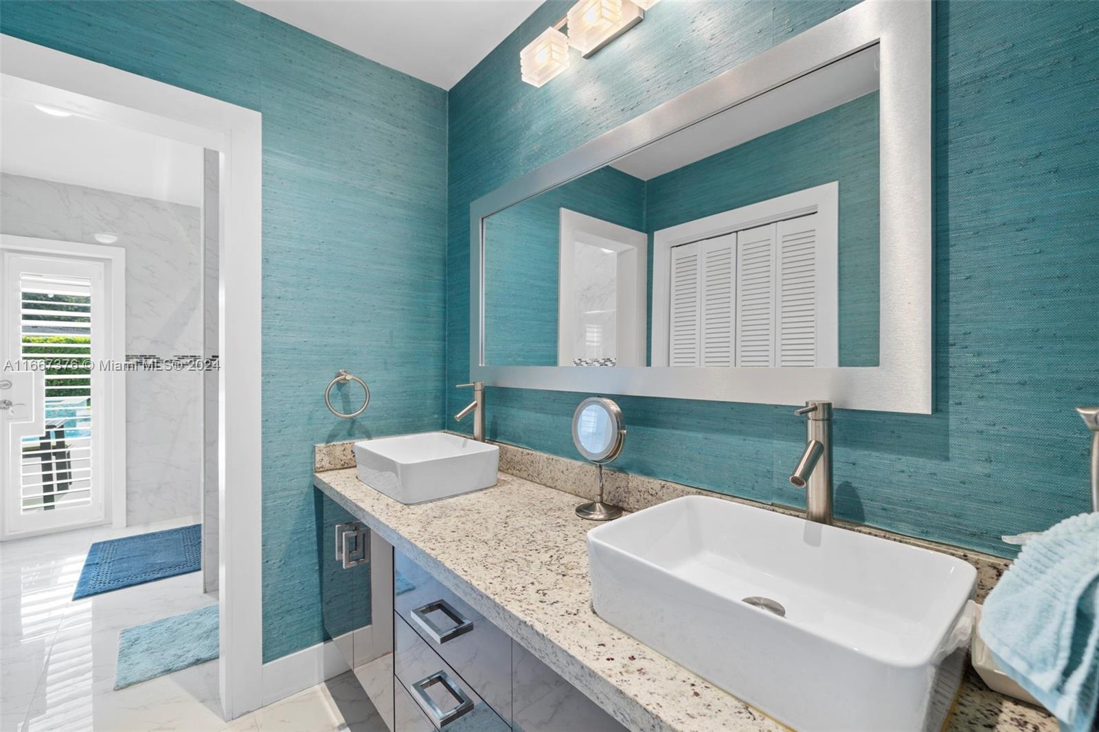 10005 Southwest 79th Avenue Miami, FL 33156 - Photo 13 of 32 a bathroom with a granite countertop sink and a mirror