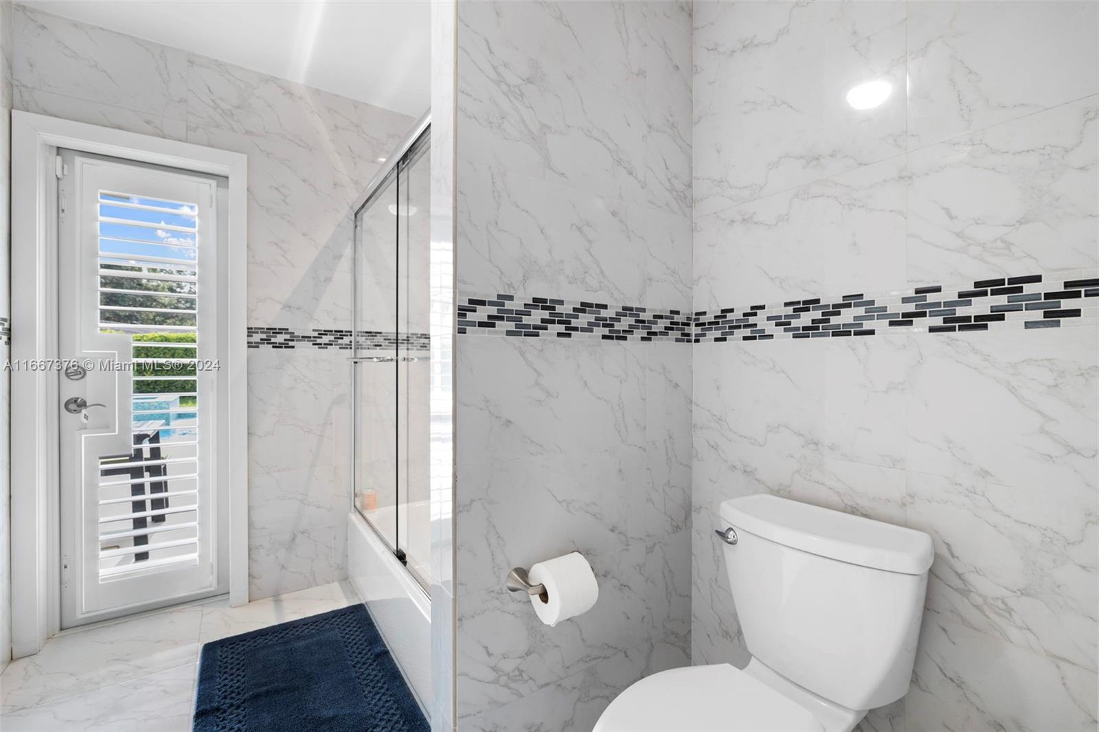 10005 Southwest 79th Avenue Miami, FL 33156 - Photo 14 of 32 a bathroom with a toilet a sink and shower