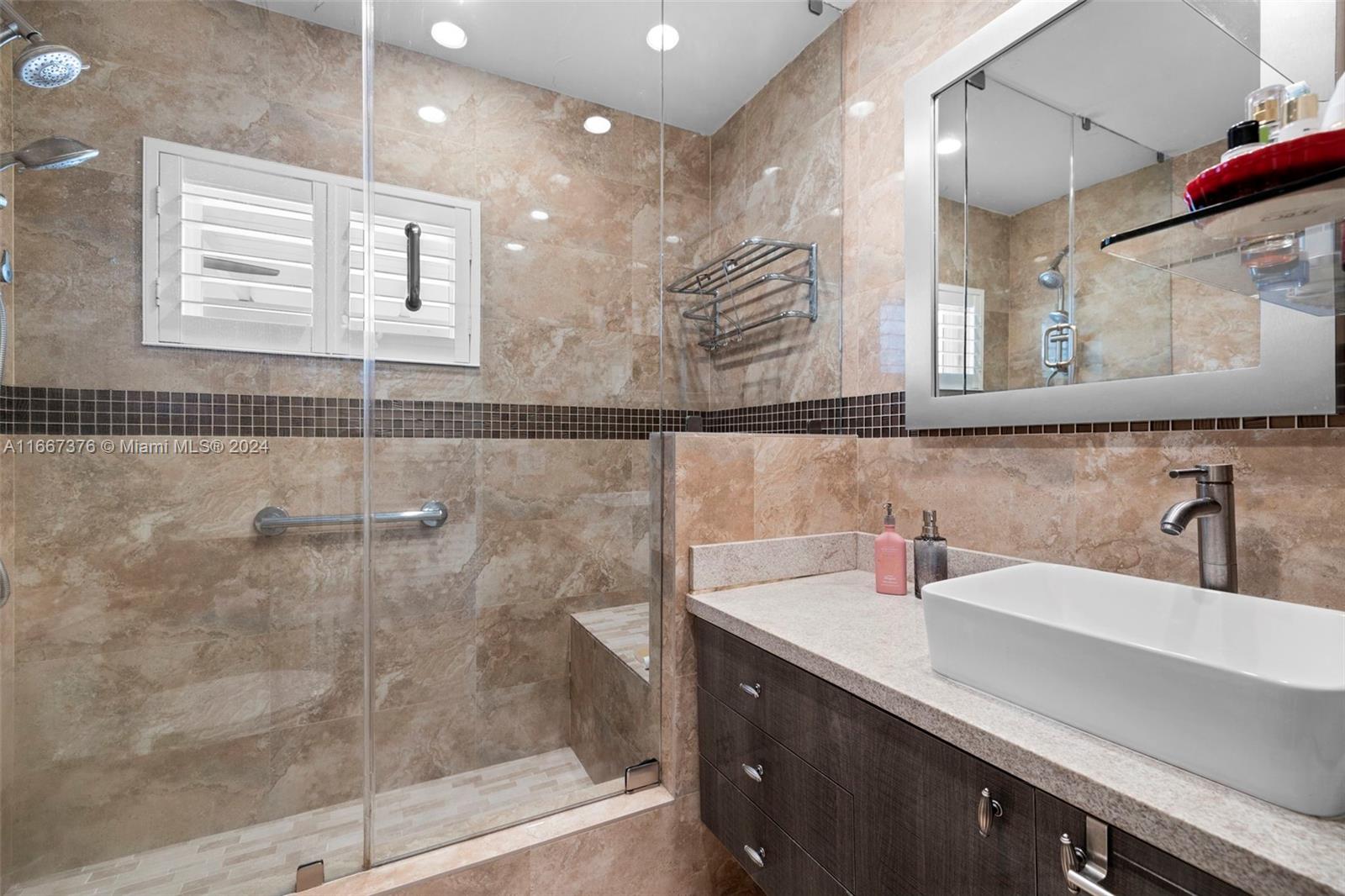 10005 Southwest 79th Avenue Miami, FL 33156 - Photo 17 of 32 a bathroom with a sink and a mirror