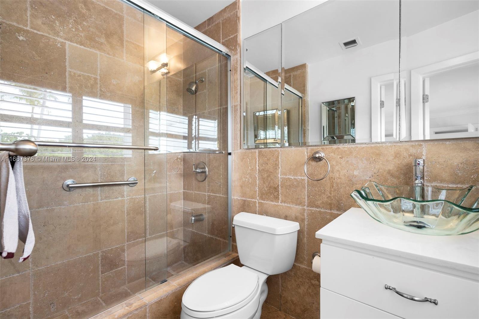 10005 Southwest 79th Avenue Miami, FL 33156 - Photo 19 of 32 a bathroom with a sink a toilet and shower