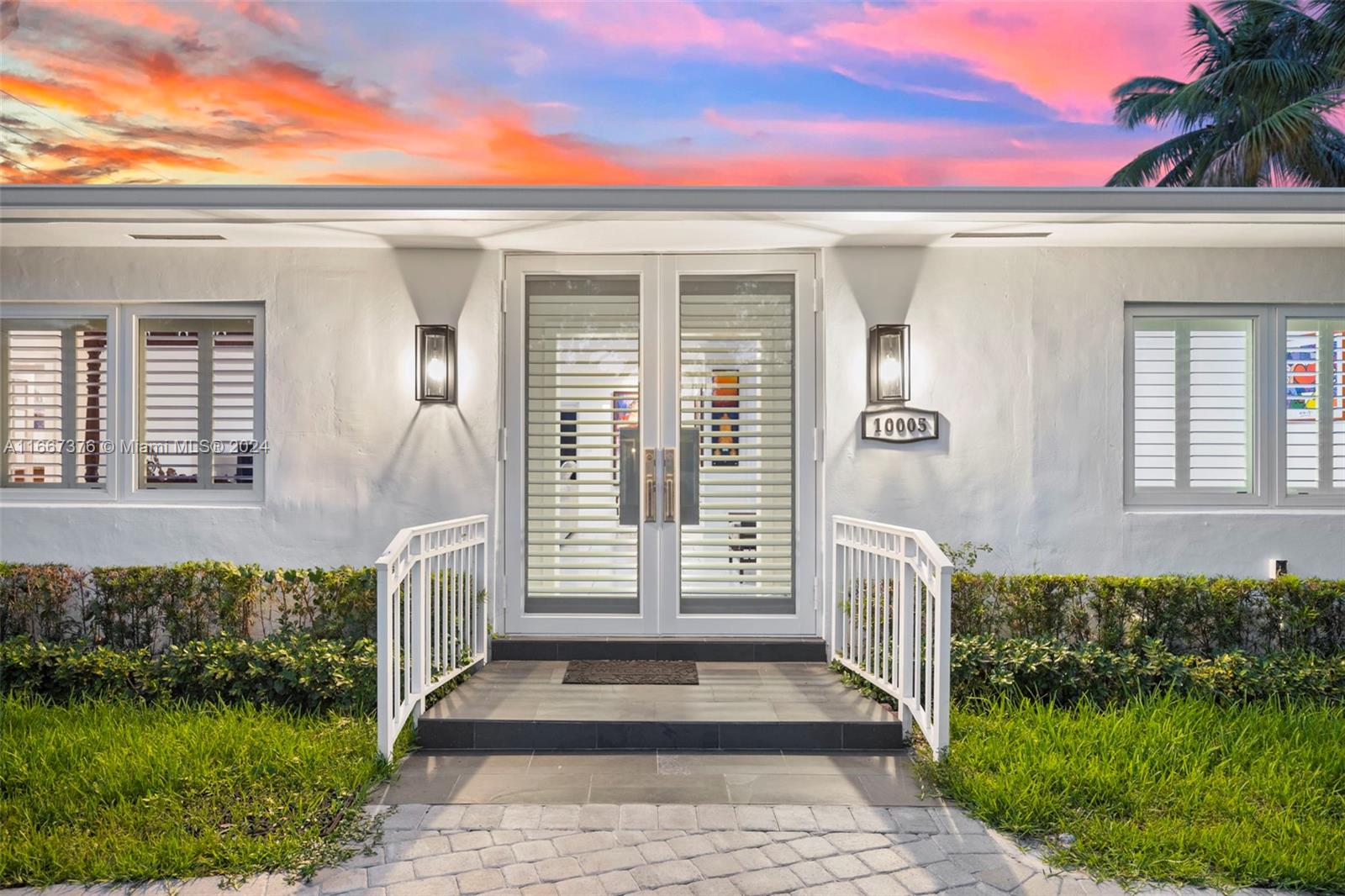 10005 Southwest 79th Avenue Miami, FL 33156 - Photo 2 of 32 a front view of a house with a porch