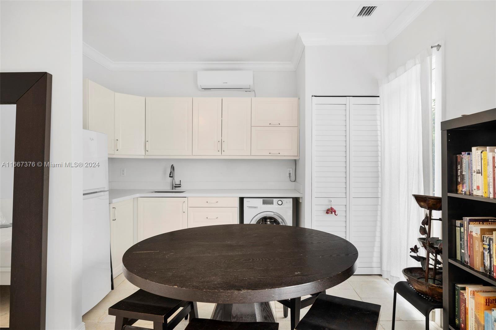 10005 Southwest 79th Avenue Miami, FL 33156 - Photo 21 of 32 a kitchen with a sink cabinets and dining table chair