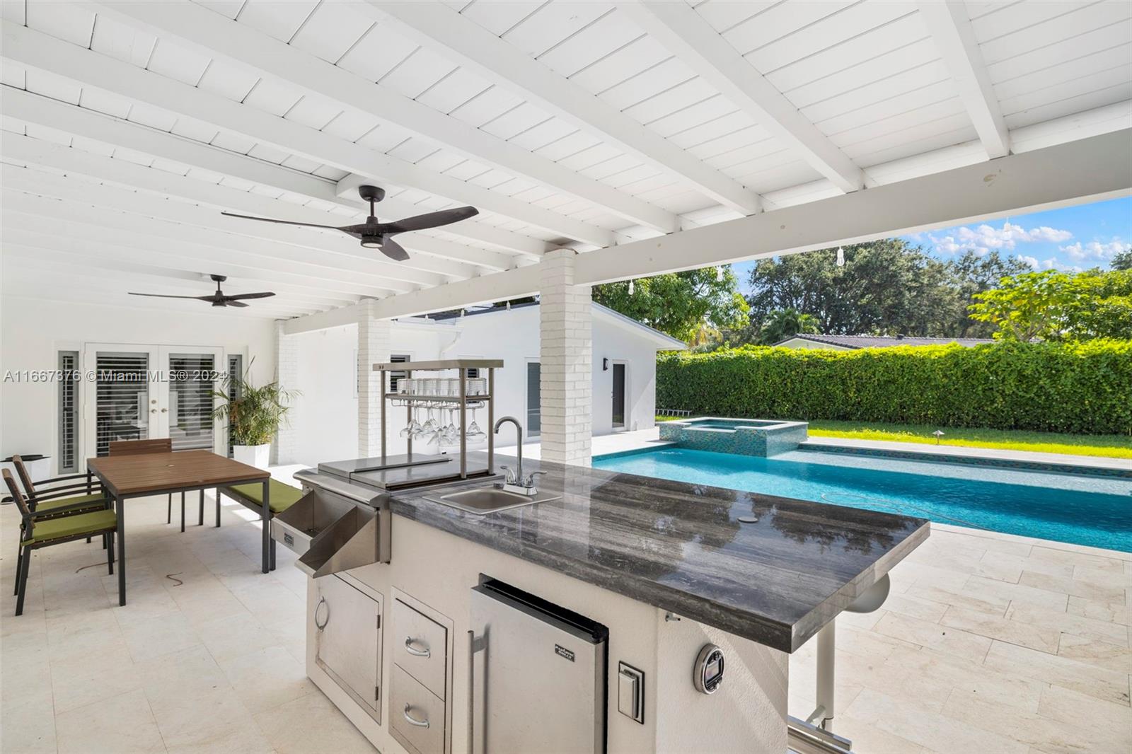 10005 Southwest 79th Avenue Miami, FL 33156 - Photo 25 of 32 a view of a porch with furniture and a yard