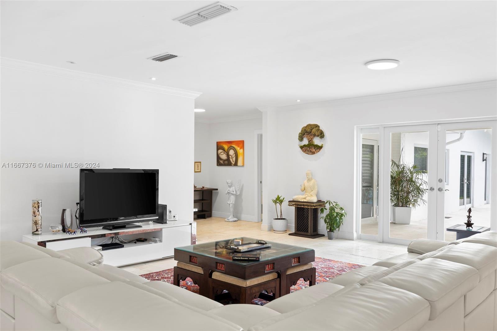 10005 Southwest 79th Avenue Miami, FL 33156 - Photo 5 of 32 a living room with furniture and a flat screen tv