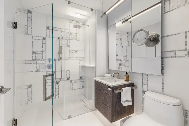 a bedroom with two beds and large window