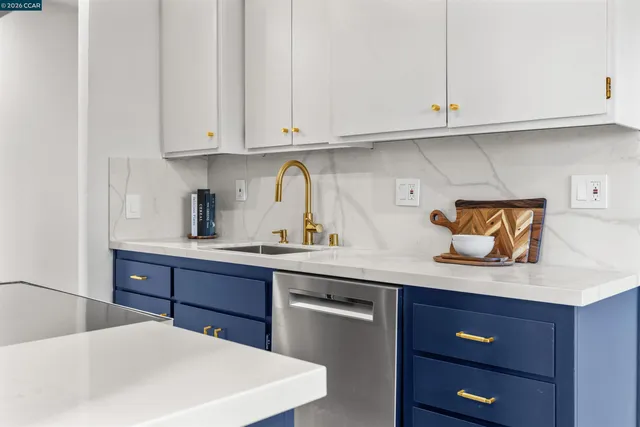 a kitchen with stainless steel appliances granite countertop a sink a stove and cabinets