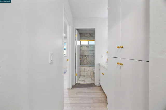 a view of a hallway with wooden floor