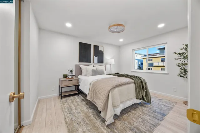 a bedroom with a bed and a large window