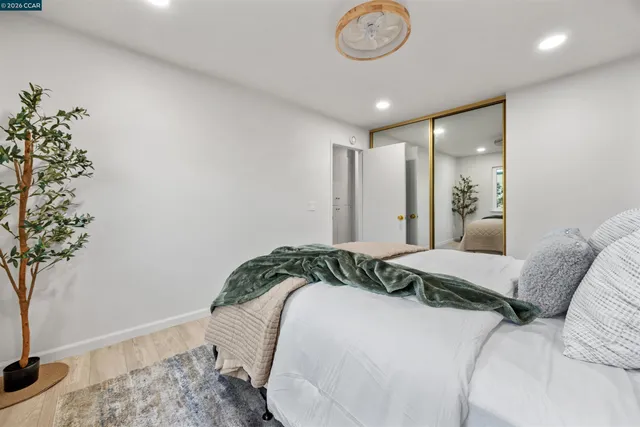 a bedroom with a bed and a potted plant