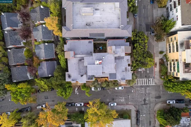an aerial view of residential houses with outdoor space