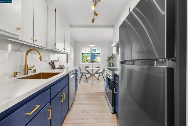 a kitchen with stainless steel appliances a sink and cabinets