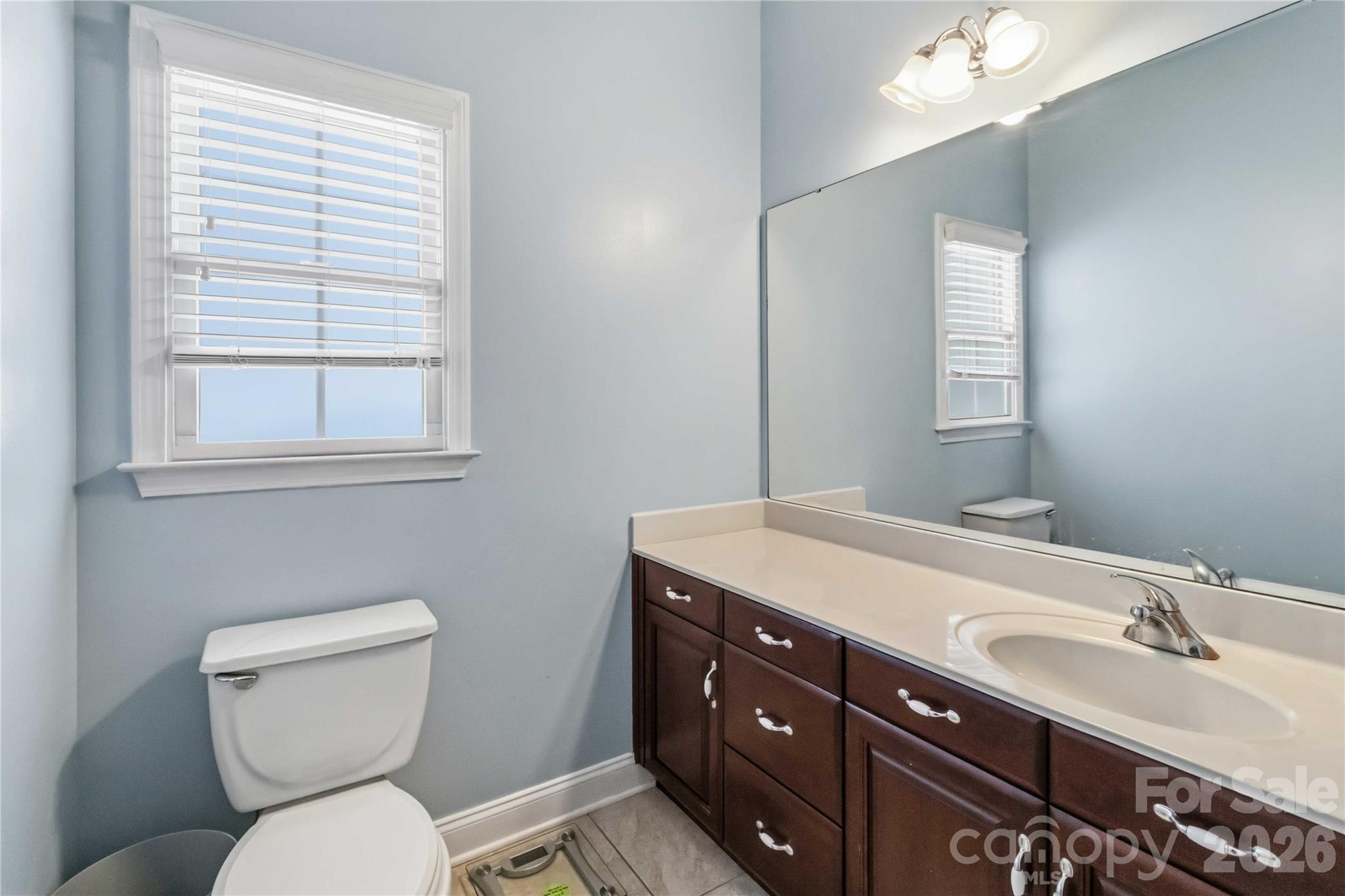 2436 Commons Court Fort Mill, SC 29708 - Photo 29 of 43 a bathroom with a toilet sink and mirror
