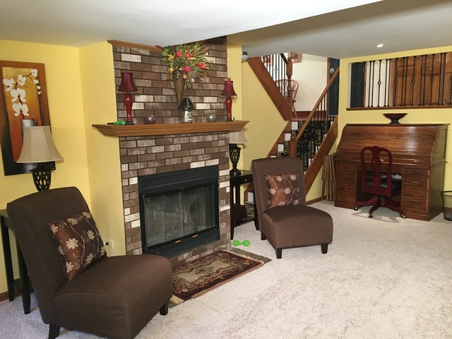 3496 Meadow Crest Circle Gurnee, IL 60031 - Photo 11 of 25 a living room with furniture a fireplace and a flat screen tv
