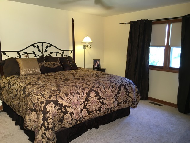 3496 Meadow Crest Circle Gurnee, IL 60031 - Photo 15 of 25 a bedroom with a bed dresser and a window