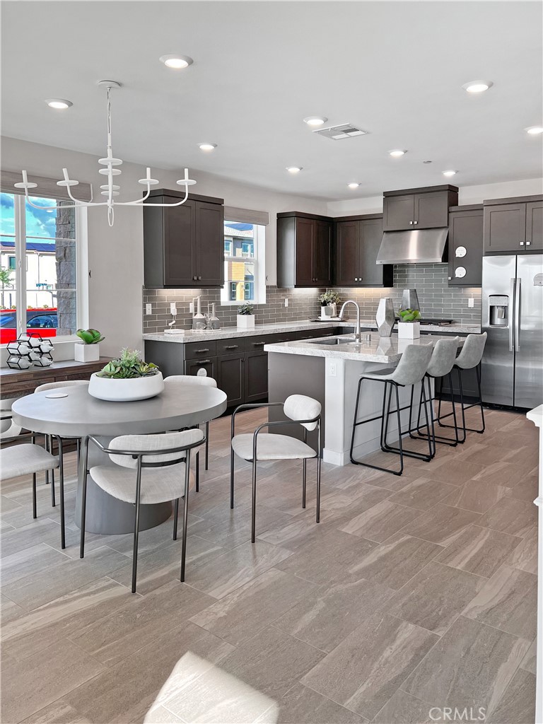 27105 Trail View Ln. Valencia, CA 91381 - Photo 2 of 30 a kitchen with a dining table chairs and view living room