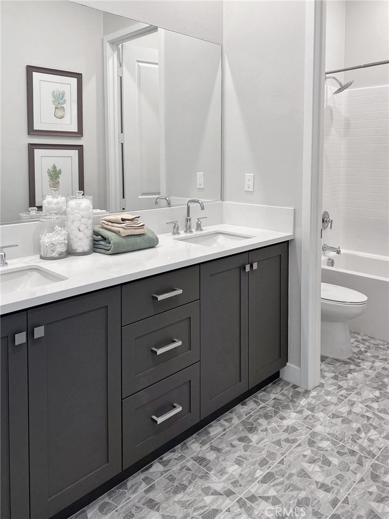 27105 Trail View Ln. Valencia, CA 91381 - Photo 21 of 30 a bathroom with a granite countertop sink and a mirror