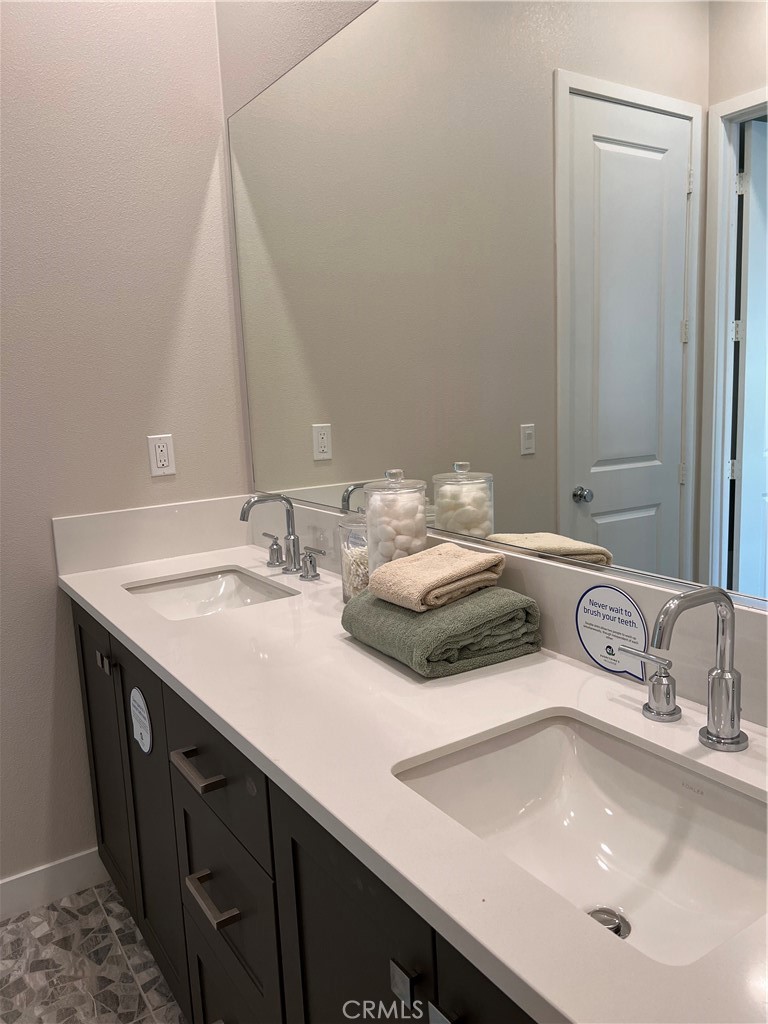 27105 Trail View Ln. Valencia, CA 91381 - Photo 22 of 30 a bathroom with a sink and a mirror