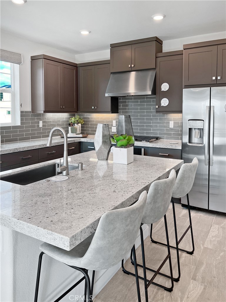 27105 Trail View Ln. Valencia, CA 91381 - Photo 4 of 30 a kitchen with stainless steel appliances granite countertop a sink and a stove
