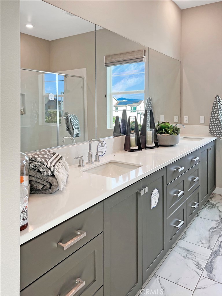 27105 Trail View Ln. Valencia, CA 91381 - Photo 9 of 30 a bathroom with a granite countertop sink and a mirror