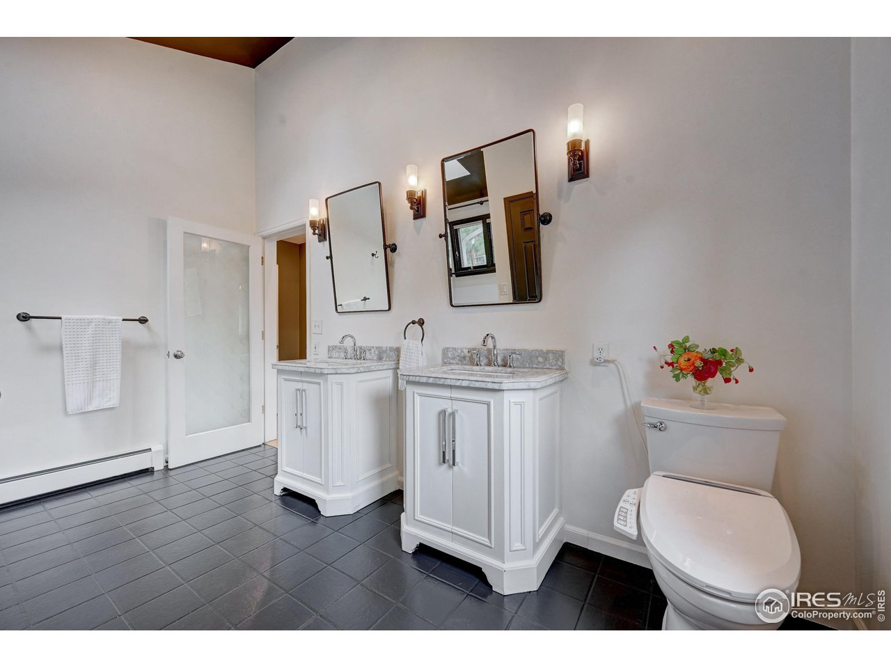 924 West Kelly Road West Boulder, CO 80302 - Photo 20 of 37 a bathroom with a toilet sink and mirror