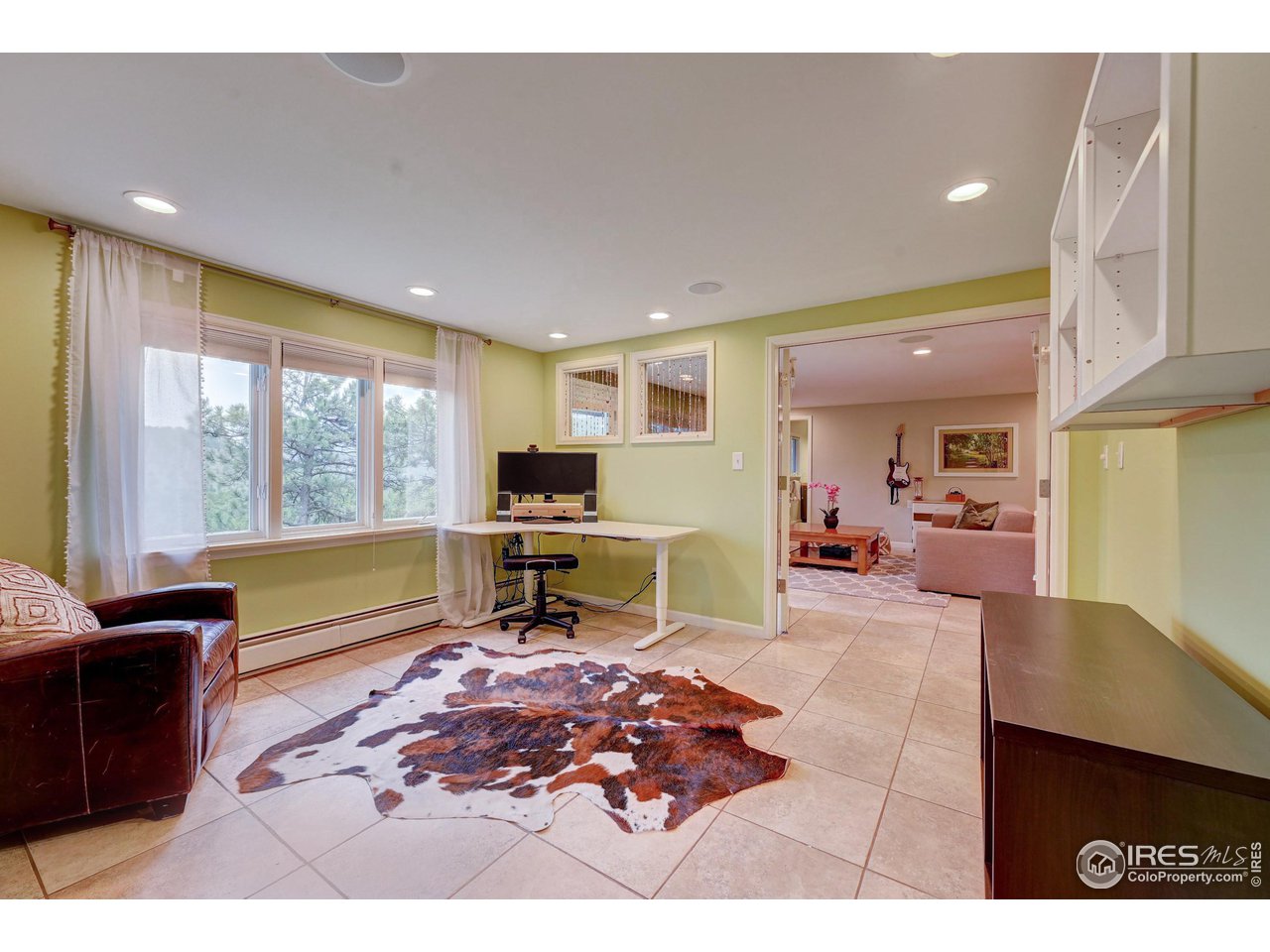 924 West Kelly Road West Boulder, CO 80302 - Photo 22 of 37 a living room with furniture a flat screen tv and large windows