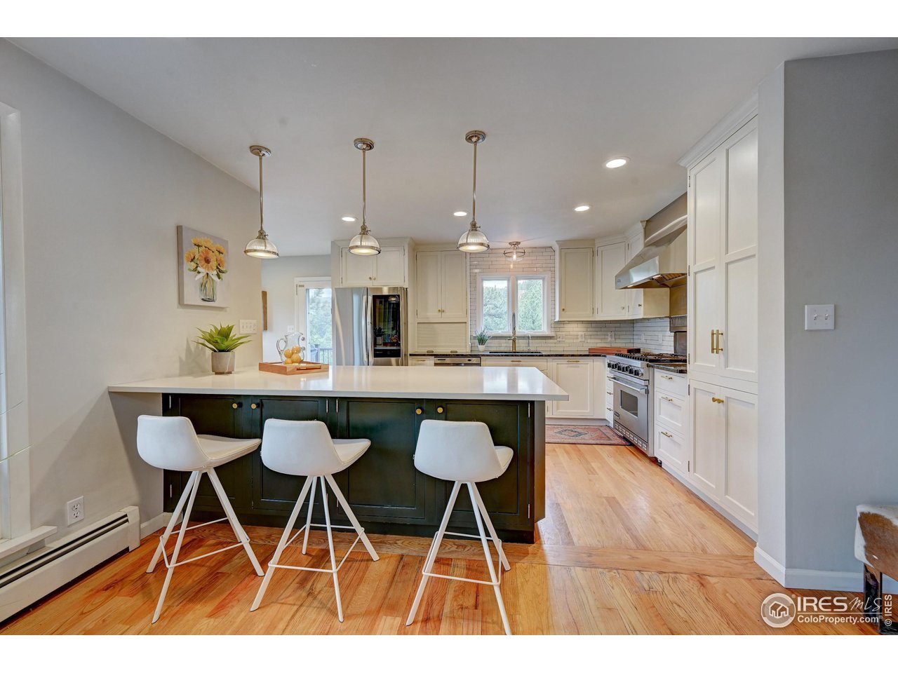 924 West Kelly Road West Boulder, CO 80302 - Photo 8 of 37 a kitchen with stainless steel appliances kitchen island granite countertop a table chairs a sink and cabinets