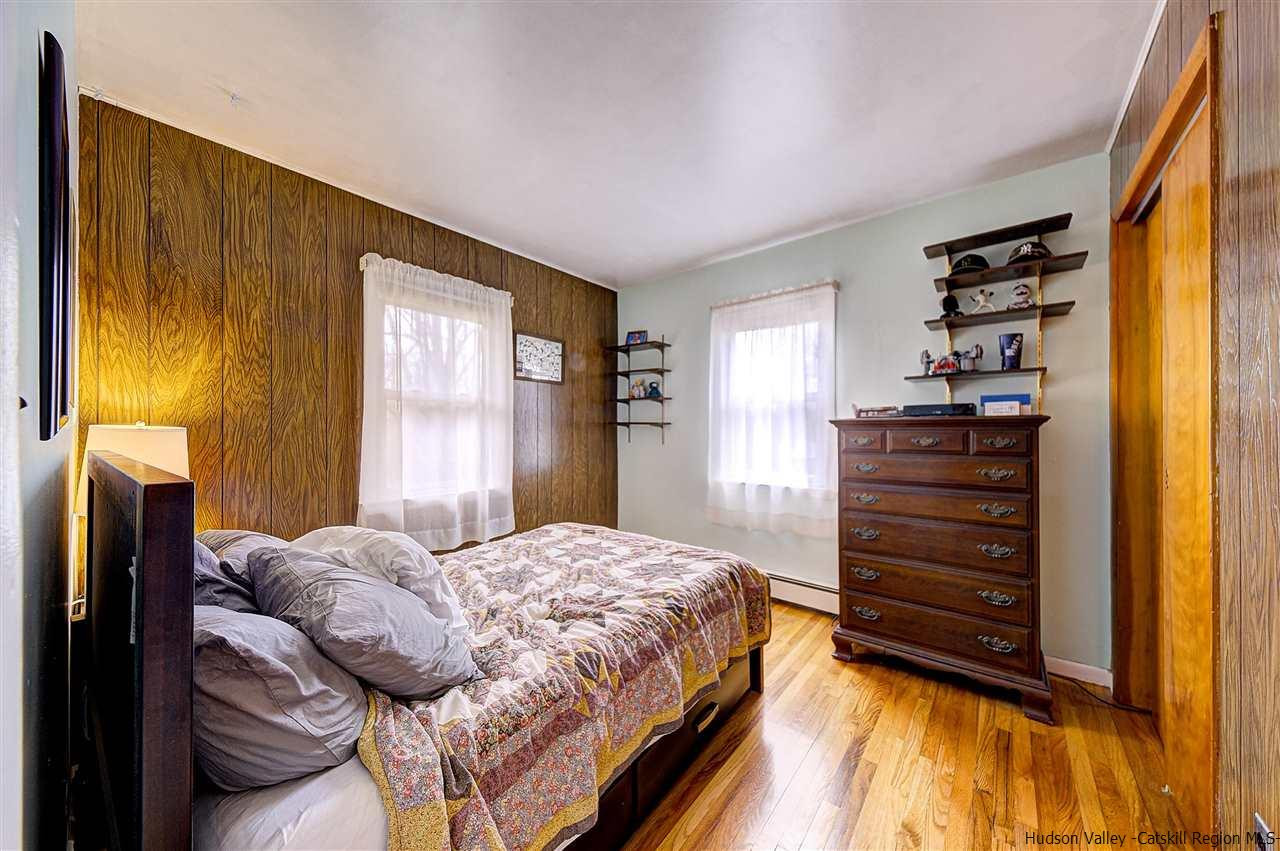 105 Gleneida Ridge Road Carmel, NY 10512 - Photo 19 of 35 a bedroom with a bed and wooden floor