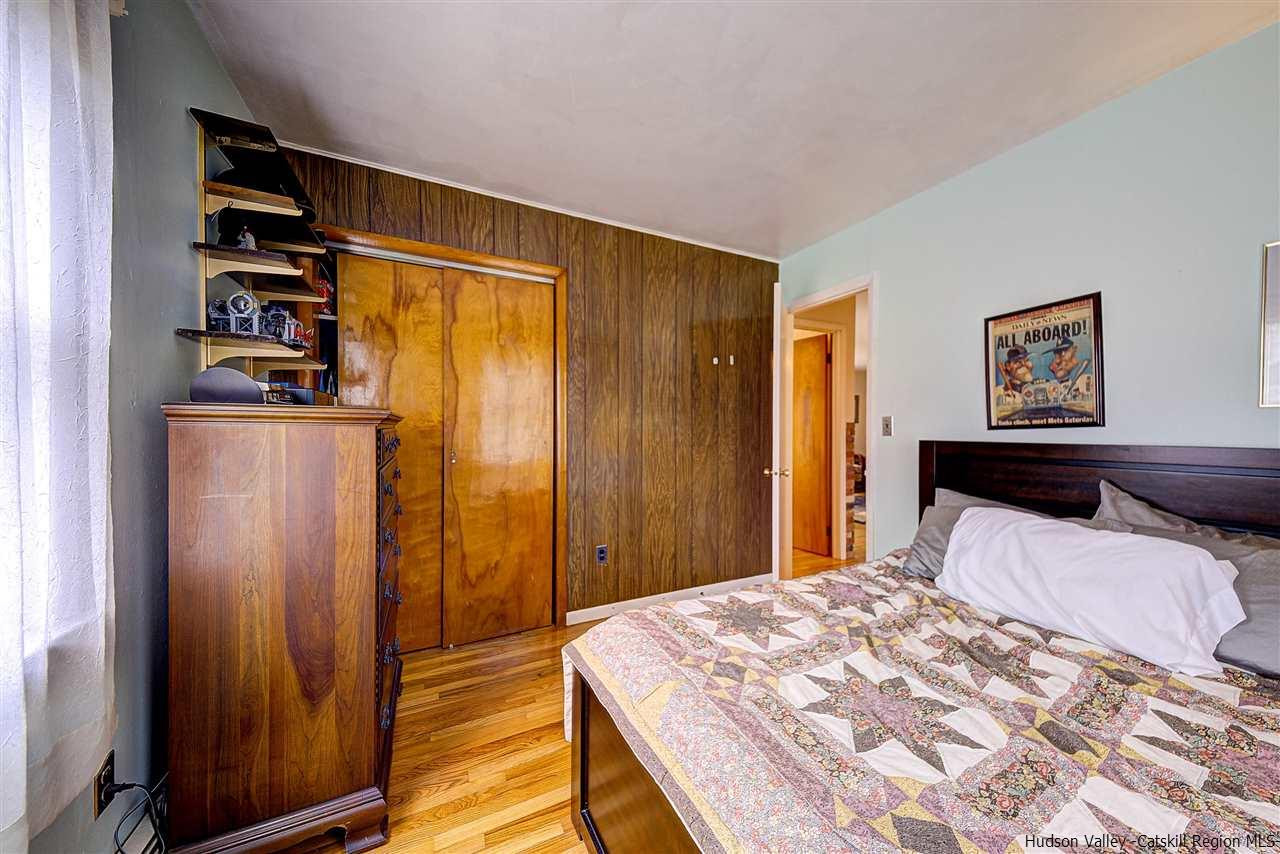 105 Gleneida Ridge Road Carmel, NY 10512 - Photo 20 of 35 a bedroom with a bed and wooden floor