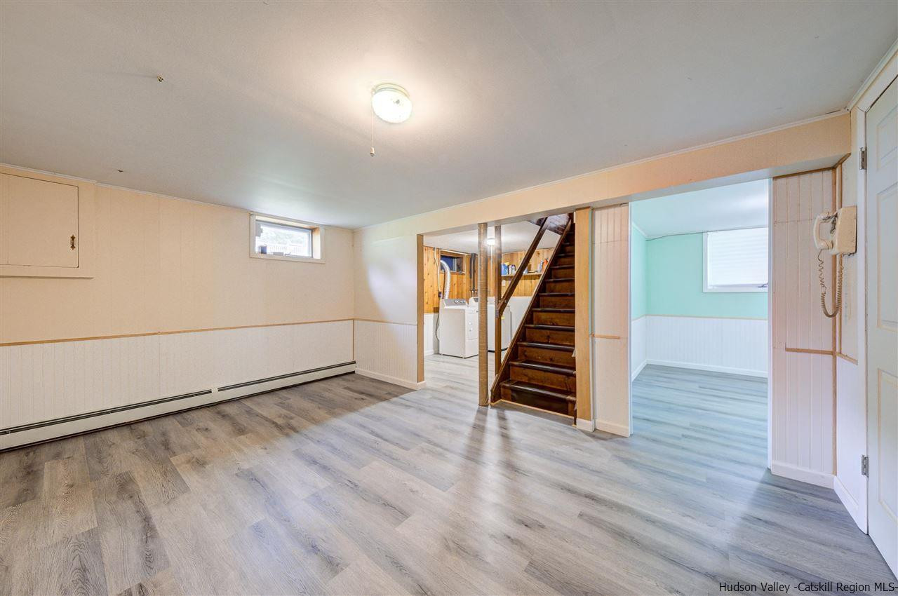 105 Gleneida Ridge Road Carmel, NY 10512 - Photo 27 of 35 an empty room with wooden floor staircase and windows