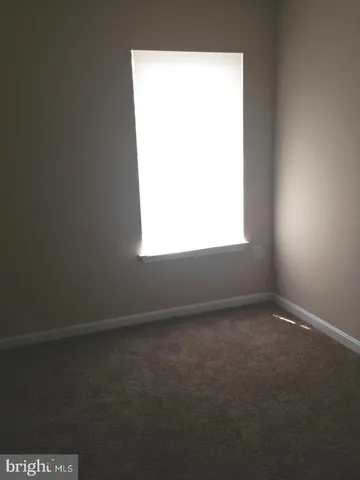 a view of an empty room and a window