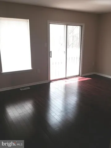a view of an empty room and wooden floor