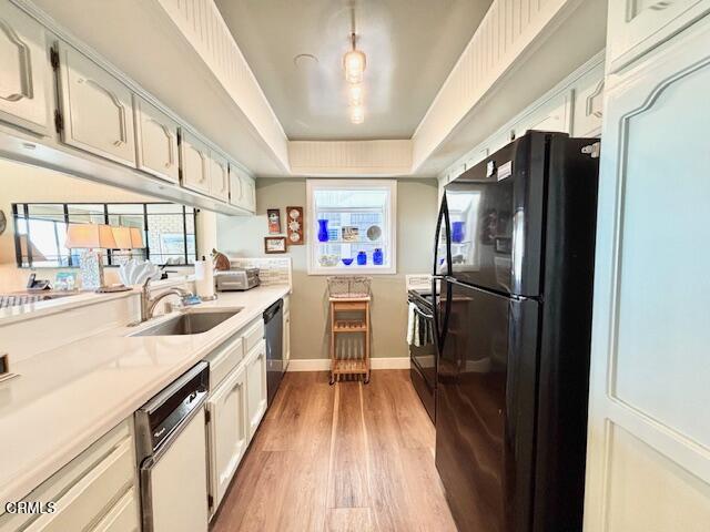 3949 Ocean Drive Oxnard, CA 93035 - Photo 16 of 24 a kitchen with stainless steel appliances granite countertop a refrigerator a sink dishwasher a stove and white countertops with wooden floor